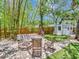 Backyard featuring a white shed, fire pit, seating area, and lush green landscaping at 2822 W Bay Ave, Tampa, FL 33611