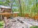 Private backyard featuring a treehouse, fire pit, and lush green landscaping at 2822 W Bay Ave, Tampa, FL 33611