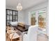 Bright dining room boasts wood floors, elegant chandelier, glass sliding doors, and display cabinet at 2822 W Bay Ave, Tampa, FL 33611