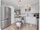 Modern kitchen featuring stainless steel appliances, white cabinets, and an island with shelving at 2822 W Bay Ave, Tampa, FL 33611