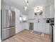 Modern kitchen featuring stainless steel appliances, white cabinets, and an island with shelving at 2822 W Bay Ave, Tampa, FL 33611