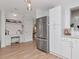 Bright and modern kitchen with stainless steel fridge and a built-in desk/workstation at 2822 W Bay Ave, Tampa, FL 33611