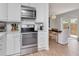 Well-lit kitchen with stainless appliances, white subway tile backsplash, and adjacent dining area at 2822 W Bay Ave, Tampa, FL 33611
