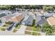 Aerial view of a gray roof house in a neighborhood with well-maintained lawns and driveways at 30217 Double Dr, Wesley Chapel, FL 33545