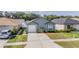 Aerial view of a single-Gathering home with a manicured lawn and a spacious, two-car driveway at 30217 Double Dr, Wesley Chapel, FL 33545