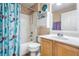 Bright bathroom with a shower-tub, vanity, mermaid curtain and functional storage at 30217 Double Dr, Wesley Chapel, FL 33545