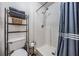Well-lit bathroom with a stand-up shower and a convenient shelving unit for storage at 30217 Double Dr, Wesley Chapel, FL 33545