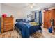 Bedroom featuring a wood floor and decorated with sports memorabilia and a ceiling fan at 30217 Double Dr, Wesley Chapel, FL 33545