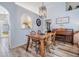 Dining room with wood table set, stylish lighting, and view of kitchen through archway at 30217 Double Dr, Wesley Chapel, FL 33545
