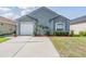 Charming single-story home with a well-manicured lawn and a two-car garage at 30217 Double Dr, Wesley Chapel, FL 33545