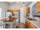 Well-lit kitchen with wood cabinets, island, stainless steel sink, and view to the backyard at 30217 Double Dr, Wesley Chapel, FL 33545