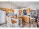 Bright kitchen with wood cabinets, island with seating, and wood-look flooring at 30217 Double Dr, Wesley Chapel, FL 33545