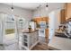Cozy kitchen featuring wood cabinets, an island, and sliding glass doors at 30217 Double Dr, Wesley Chapel, FL 33545