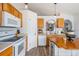 Bright kitchen featuring light wood cabinets, white appliances, and a butcher block island at 30217 Double Dr, Wesley Chapel, FL 33545