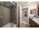Bathroom featuring tub/shower combo with tiled surround, single sink vanity and modern finishes at 3273 Tanglewood Trl, Palm Harbor, FL 34685