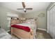 Bright bedroom with a ceiling fan, carpet, and a window with natural light at 3273 Tanglewood Trl, Palm Harbor, FL 34685