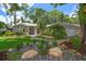 Charming single-story home featuring meticulously maintained landscaping, mature trees, and a welcoming front entrance at 3273 Tanglewood Trl, Palm Harbor, FL 34685