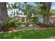 Inviting single-story home with lush landscaping, stone accents, and well-manicured lawn at 3273 Tanglewood Trl, Palm Harbor, FL 34685