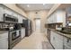 Well-lit kitchen featuring stainless steel appliances, white cabinets and granite countertops at 3273 Tanglewood Trl, Palm Harbor, FL 34685