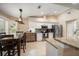 Well-lit kitchen with white cabinets, granite countertops, stainless steel appliances, and an adjacent dining space at 3273 Tanglewood Trl, Palm Harbor, FL 34685