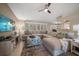 Cozy living room featuring a comfortable sectional sofa, large windows, and modern décor at 3273 Tanglewood Trl, Palm Harbor, FL 34685