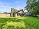 Lush backyard featuring a well-manicured lawn and an enclosed pool area at 3305 Westmoreland Dr, Tampa, FL 33618