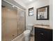 Bathroom features a tiled shower with glass door, toilet, and modern vanity with a dark wood cabinet at 3305 Westmoreland Dr, Tampa, FL 33618