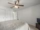 Bedroom featuring a ceiling fan, carpet flooring, sliding-door closets, and a television at 3305 Westmoreland Dr, Tampa, FL 33618