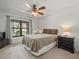 Cozy bedroom with large window allowing plenty of natural light and a ceiling fan for added comfort at 3305 Westmoreland Dr, Tampa, FL 33618