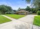Suburban brick home with a lush lawn and a long driveway at 3305 Westmoreland Dr, Tampa, FL 33618