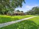 Beautifully landscaped home with mature trees and a well-maintained lawn at 3305 Westmoreland Dr, Tampa, FL 33618