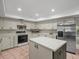 Bright kitchen with stainless steel appliances, a center island, and plenty of cabinet space at 3305 Westmoreland Dr, Tampa, FL 33618