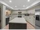Well-lit kitchen featuring a center island, ample counter space, and modern appliances at 3305 Westmoreland Dr, Tampa, FL 33618