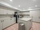 Large kitchen featuring a center island, stainless steel refrigerator, and ample cabinet storage at 3305 Westmoreland Dr, Tampa, FL 33618