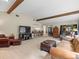 Large living room with exposed beams connects to the breakfast bar, dining area, and screened-in pool at 3305 Westmoreland Dr, Tampa, FL 33618