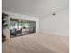 Spacious living room with neutral carpeting and access to the outdoor pool area at 3305 Westmoreland Dr, Tampa, FL 33618