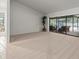 Bright living room with neutral carpet and sliding doors to the pool area at 3305 Westmoreland Dr, Tampa, FL 33618