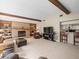 Open concept living area with exposed wood beams, fireplace, and breakfast bar to the kitchen at 3305 Westmoreland Dr, Tampa, FL 33618