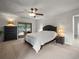 Bright main bedroom featuring a ceiling fan, a dark wood dresser, and a sliding door to the pool at 3305 Westmoreland Dr, Tampa, FL 33618
