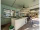 Covered outdoor kitchen with cooktop, bar seating, and a view to the indoors at 3305 Westmoreland Dr, Tampa, FL 33618