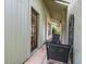 Outdoor patio area featuring dark metal chairs, brick columns, and access to the home through a glass pane door at 3305 Westmoreland Dr, Tampa, FL 33618