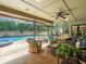 Inviting covered patio featuring comfortable wicker furniture overlooking a refreshing pool and spa at 3305 Westmoreland Dr, Tampa, FL 33618