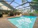Spacious screened-in pool with a spa, patio seating, and views of the well-maintained backyard at 3305 Westmoreland Dr, Tampa, FL 33618