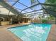A screened in pool and patio, with chairs, an outdoor kitchen and fenced yard at 3305 Westmoreland Dr, Tampa, FL 33618