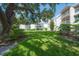 A lush green lawn and gardens frame a building with balconies, creating a serene outdoor space at 3325 Bayshore Blvd # A17, Tampa, FL 33629