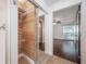 Bathroom featuring modern vanity, glass shower door, and wood-look tile at 3325 Bayshore Blvd # A17, Tampa, FL 33629