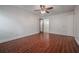 A bedroom with wood-look flooring, ceiling fan, and a doorway to the bathroom at 3325 Bayshore Blvd # A17, Tampa, FL 33629