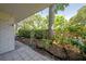 View of the courtyard from the covered patio with a large tree surrounded by lush plantings at 3325 Bayshore Blvd # A17, Tampa, FL 33629