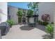 Courtyard with outdoor table under an umbrella with blue chairs and lush landscaping around the common area at 3325 Bayshore Blvd # A17, Tampa, FL 33629