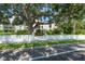 Exterior view of a building with mature trees, a brick wall, and lush landscaping at 3325 Bayshore Blvd # A17, Tampa, FL 33629